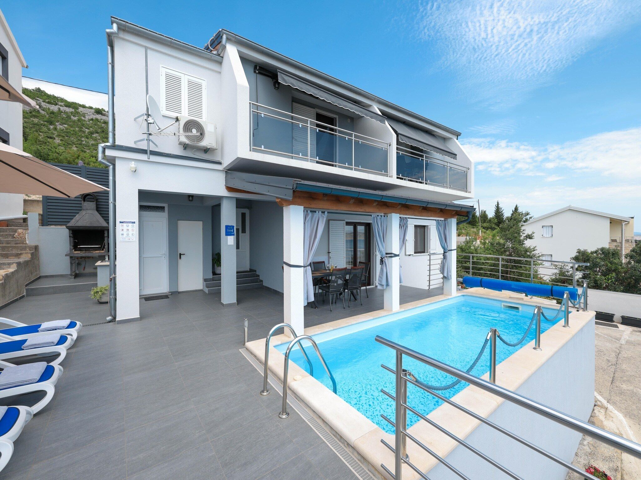 A heated pool, sun loungers
