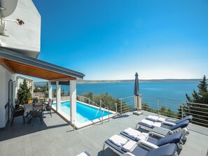 A heated pool, pool loungers