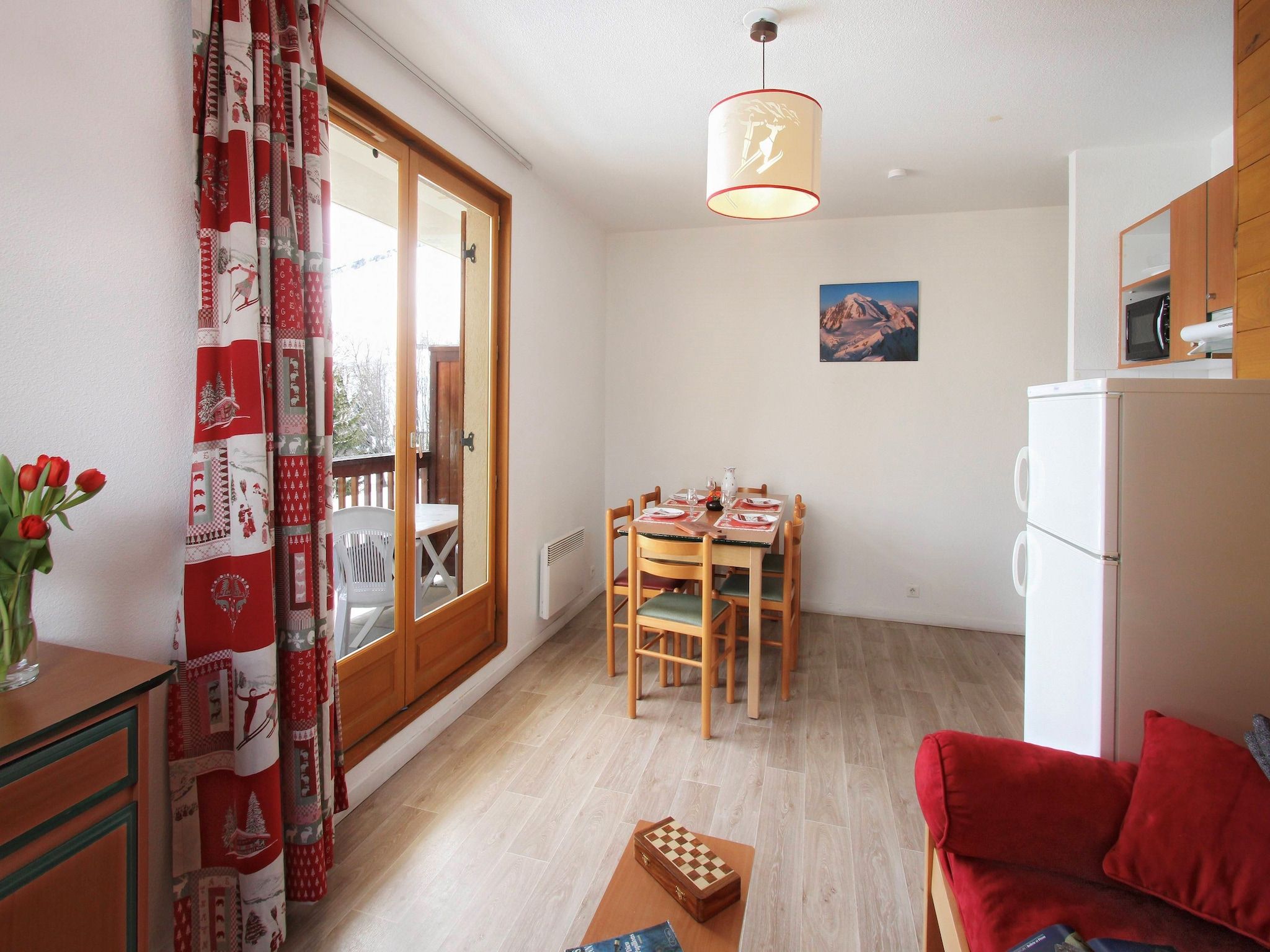 A compact living space with a dining area, a kitchen, and a seating area.