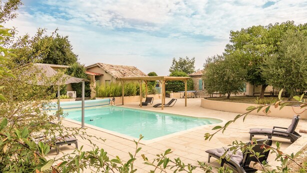A pool area with lounge chairs and a pergola. - Villa in Saint-Nexans with Private Heated Pool (Saint-Nexans)