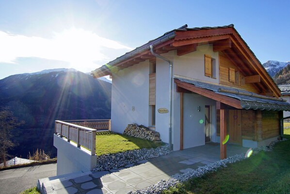 Situated in a mountainous area, this chalet-style building offers a scenic view of the surrounding landscape.