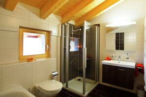Enjoy a refreshing shower in the bathroom with a glass-enclosed shower, sink, and toilet.