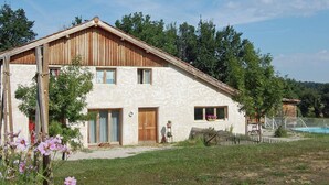 A rustic two-story house with a wooden facade, a front door, and a small porch area. - Pretty Villa With Private Pool in Montadet France (Montadet)