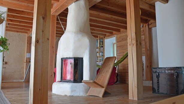 A rustic wooden interior with a stone fireplace, wooden beams, and a bookshelf in the background. - Pretty Villa With Private Pool in Montadet France (Montadet)