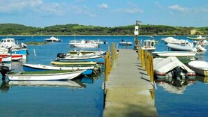 A marina with various boats docked along a wooden pier. - Farmhouse in Suvereto near Etruscan Coast (Suvereto)