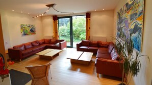 A modern living room with a sectional sofa, a coffee table, and a large window.