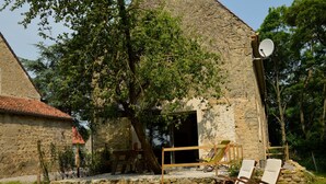 A stone building with a sloped roof, a satellite dish, and a patio area with two lounge chairs. - Holiday Home near Opal Coast Wierre-Effroy (Wierre-Effroy (Londefort))