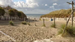 A sandy beach with wooden fences and a clear sky.