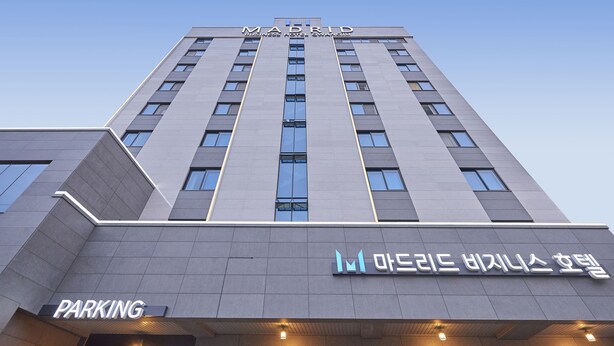 A modern building with a sign for 'Madrid Business Hotel' and a 'Parking' entrance. - Madrid Hotel Gwangju (Gwangju)