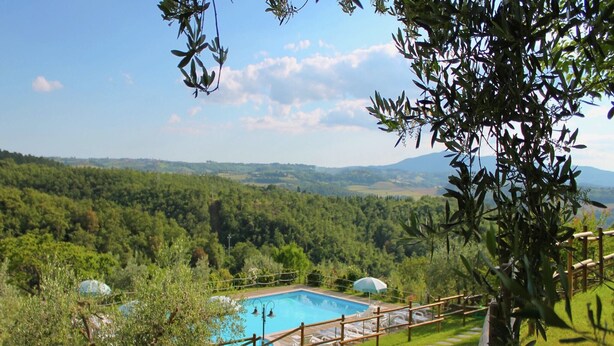 A pool area with a view of a forested valley and mountains in the distance. - Scenic Farmhouse with Pool (Città Della Pieve)
