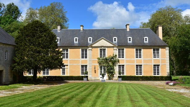 A large, historic building with a symmetrical facade, multiple windows, and a central entrance. - Elegant Manor Retreat Normandy (Lantheuil)