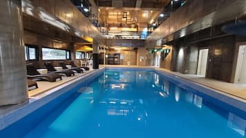 Indoor pool, open 3:00 PM to 10:00 PM, pool umbrellas