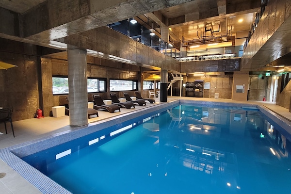 Indoor pool, open 3:00 PM to 10:00 PM, pool umbrellas