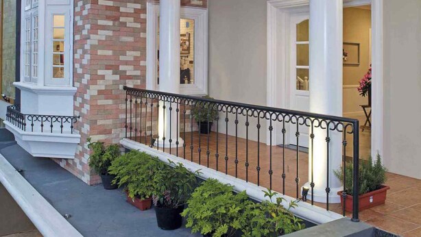 A multi-level building with a balcony, white columns, and potted plants. - Cottonwood Bed & Breakfast House (Bandung)