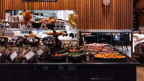 A buffet with various food items and condiments.