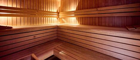 A sauna with wooden benches and a bench for sitting.