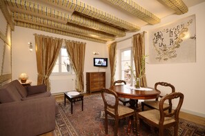 Suite Confort | Zona de estar | Una televisión de pantalla plana