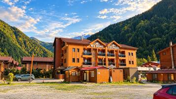 A hotel with a sign reading 'MY HOME UZUNGÖL' in a mountainous area.