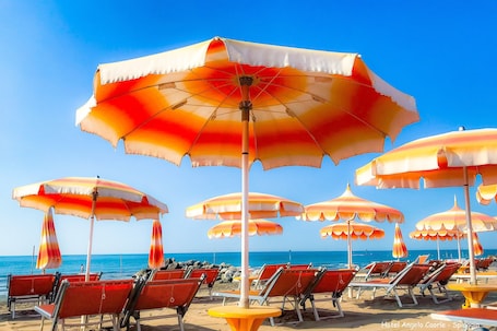 Private beach nearby, white sand, sun loungers, beach umbrellas. Hotel Angelo