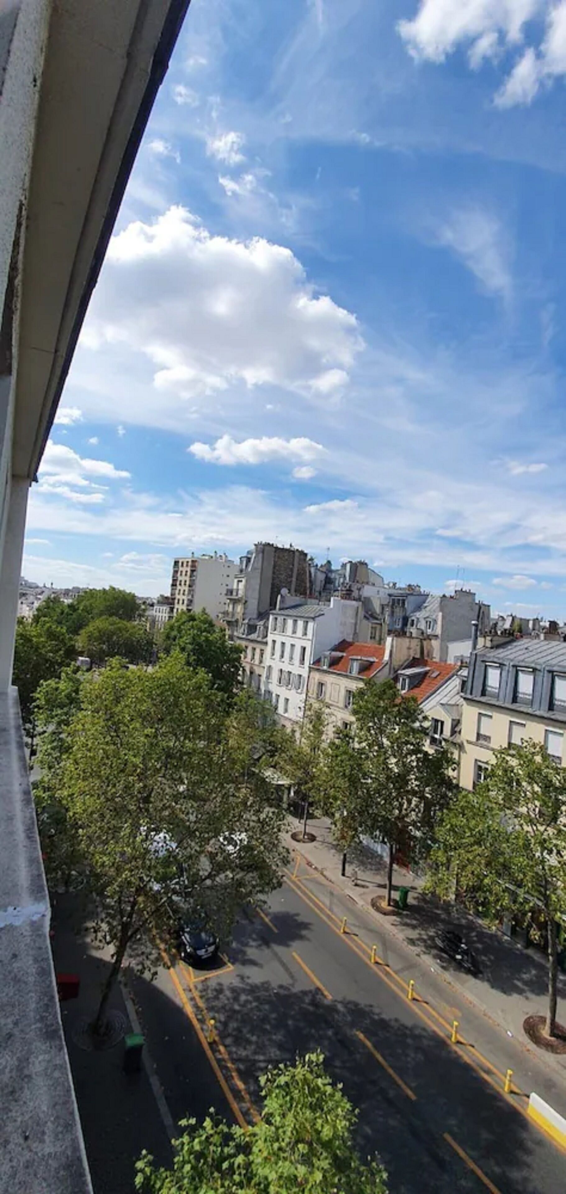 A cityscape with buildings, trees, and a clear sky.