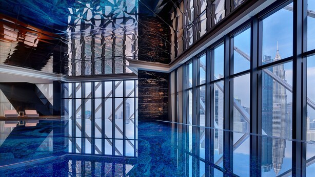 A modern hotel interior with a glass-bottomed pool reflecting the city skyline, large windows, and contemporary design elements. - Element by Marriott Kuala Lumpur (Kuala Lumpur)
