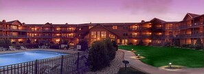 A large hotel with multiple balconies, a swimming pool, and a well-maintained lawn. - Scandinavian Lodge (Sister Bay)