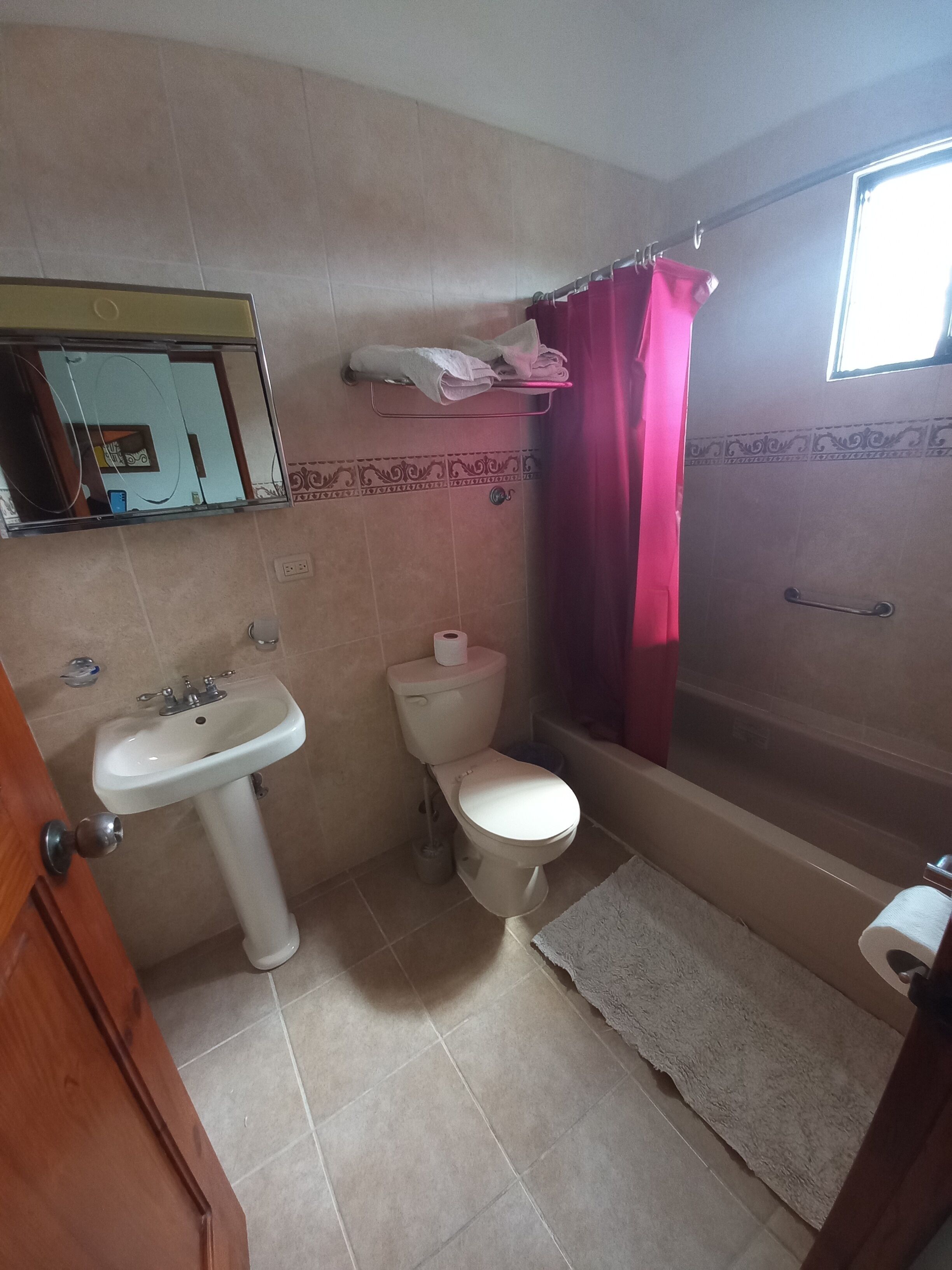 A bathroom with a sink, toilet, and bathtub.