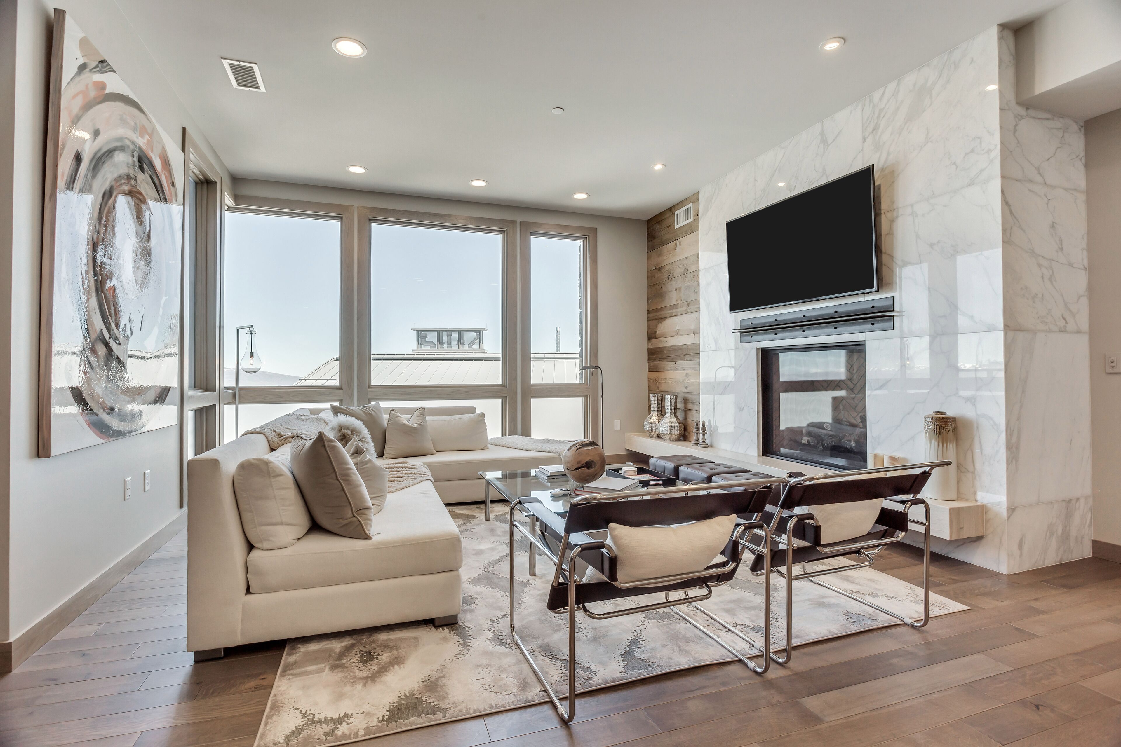 A modern living room with a sofa, coffee table, and a fireplace.