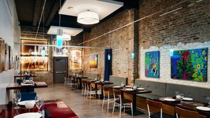 A restaurant with brick walls, wooden tables, and modern lighting fixtures. - The Waters Hot Springs, Tapestry Collection by Hilton (Hot Springs)