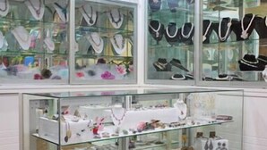 A jewelry store with glass display cases containing various necklaces and bracelets. - One Hotel Lintas Jaya (Kota Kinabalu)