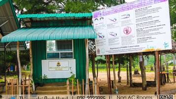 A small structure with a green roof and a signboard for Sri Lanka Coast Guard.