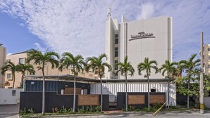 A hotel with a modern design, featuring a prominent sign for 'Hotel Sunset Terrace'.