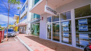 A Citylights Hotel with a clear view of the entrance, a signboard, and a Chili Panda restaurant across the street. - CityLights Hotel (Perth)