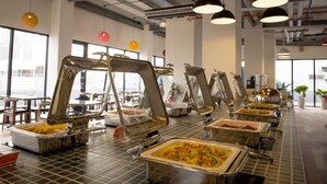 A buffet setup with multiple serving stations and overhead lighting. - Legend Hotel Pier 2 (Kaohsiung)