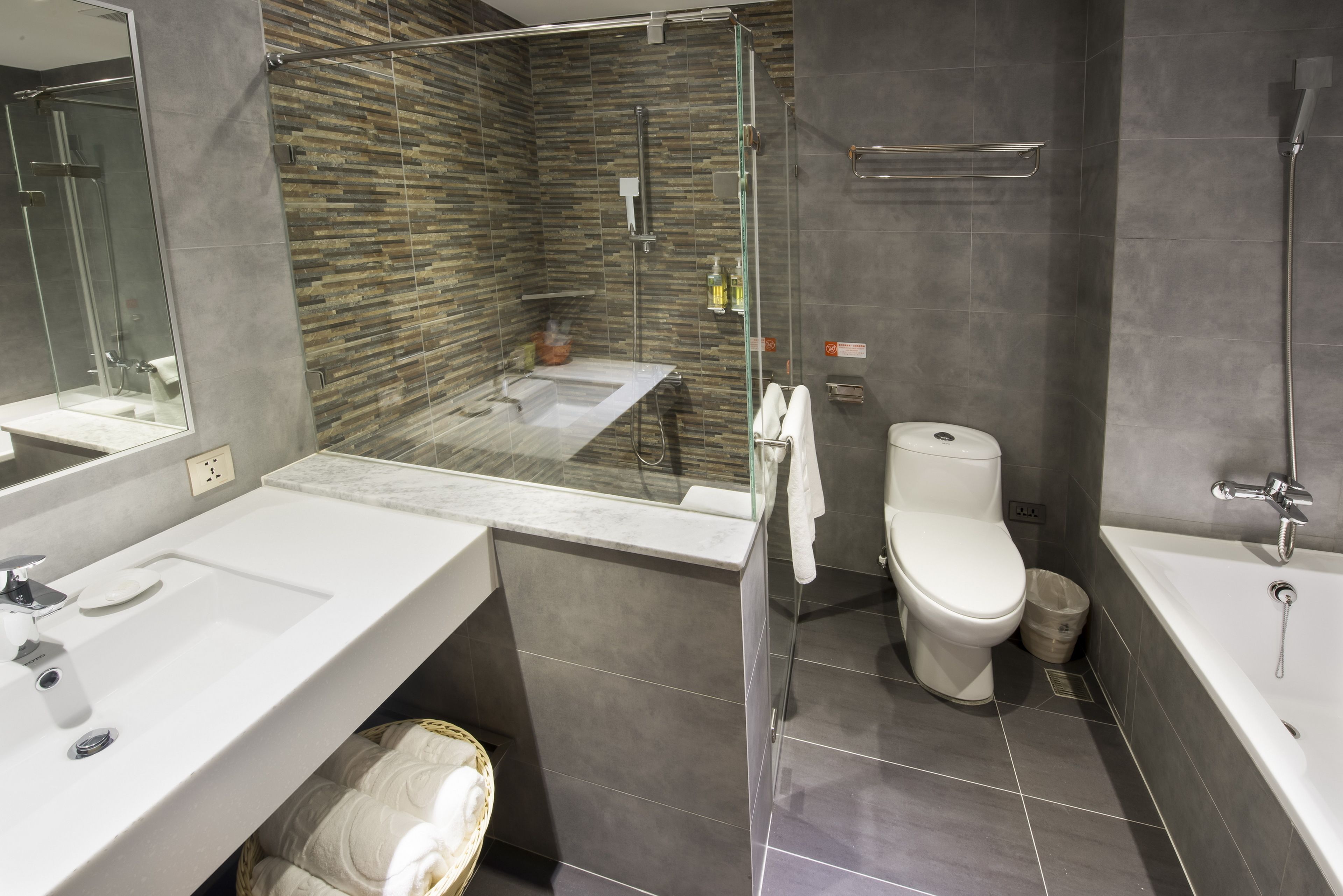 deluxe kingbed room | bathroom | separate bathtub and shower, hair dryer, towels, shampoo