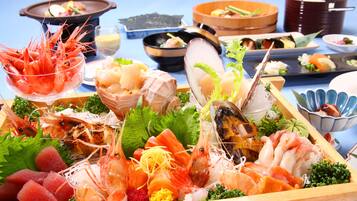 A variety of seafood arranged on a wooden tray.