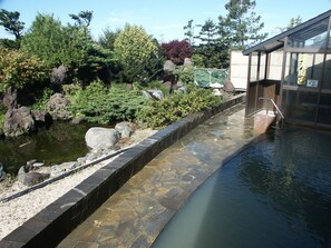 A stone pathway leading to a building with a sign in a foreign language. - Haboro Onsen Sunset Plaza (Haboro)