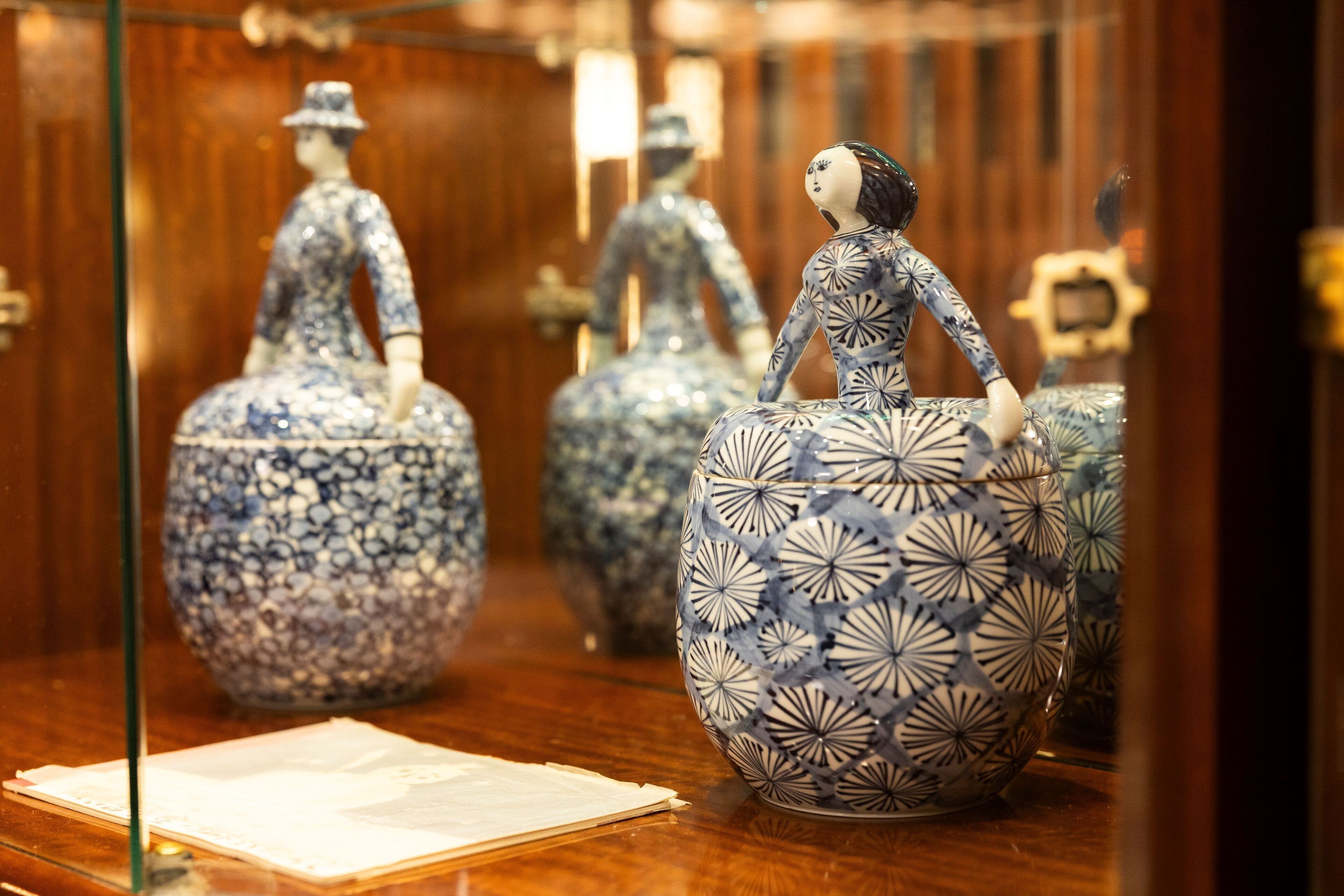A display of ceramic figurines in a museum setting.