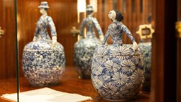 A display of ceramic figurines in a museum setting.