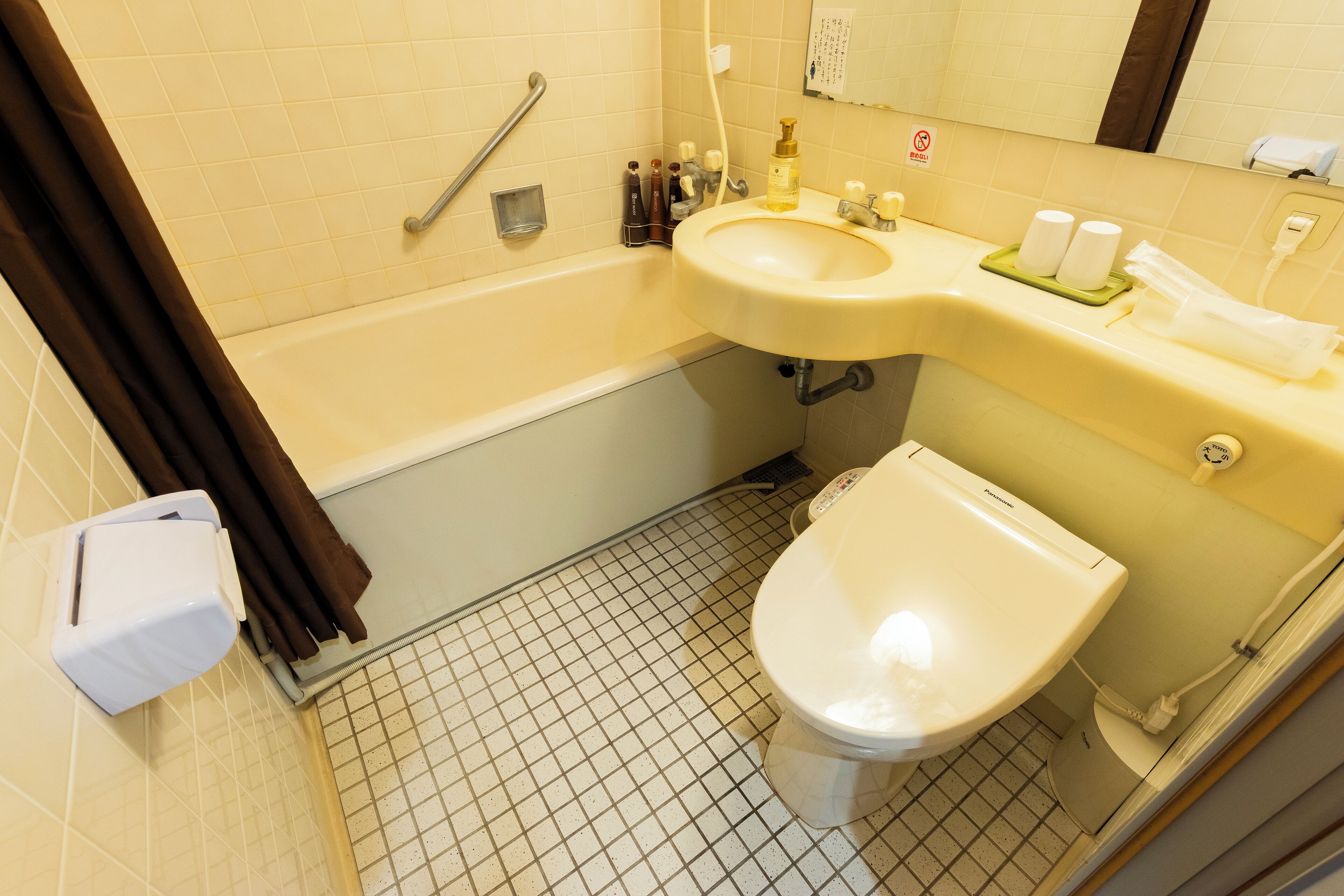 A bathroom with a bathtub, a sink, and a toilet.