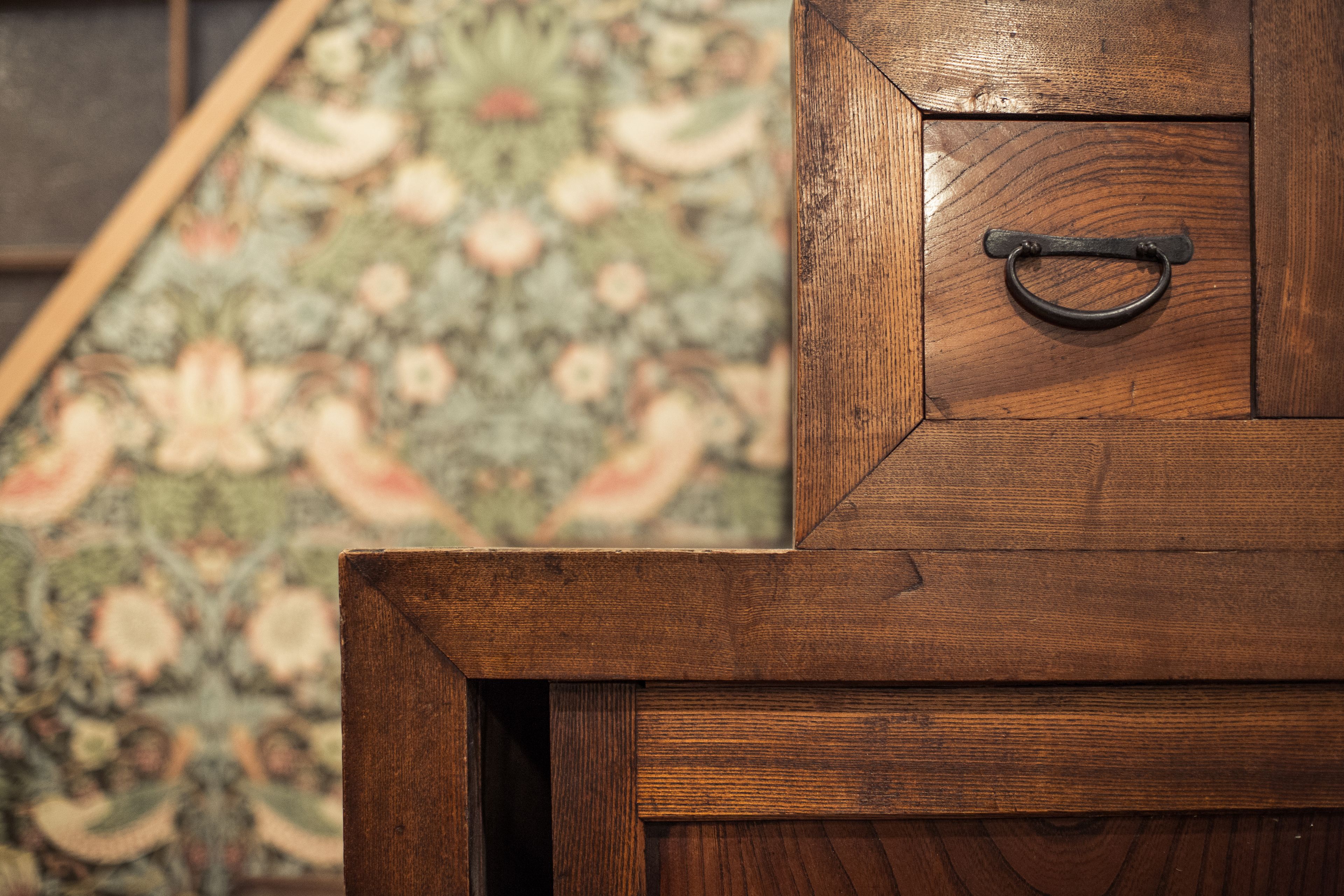 A wooden cabinet with a metal handle.