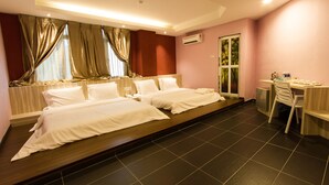 A hotel room with two beds, a desk, and a chair. - JS Hotel (Johor Bahru)