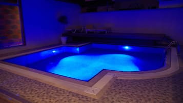 Una piscina al aire libre de temporada, sombrillas