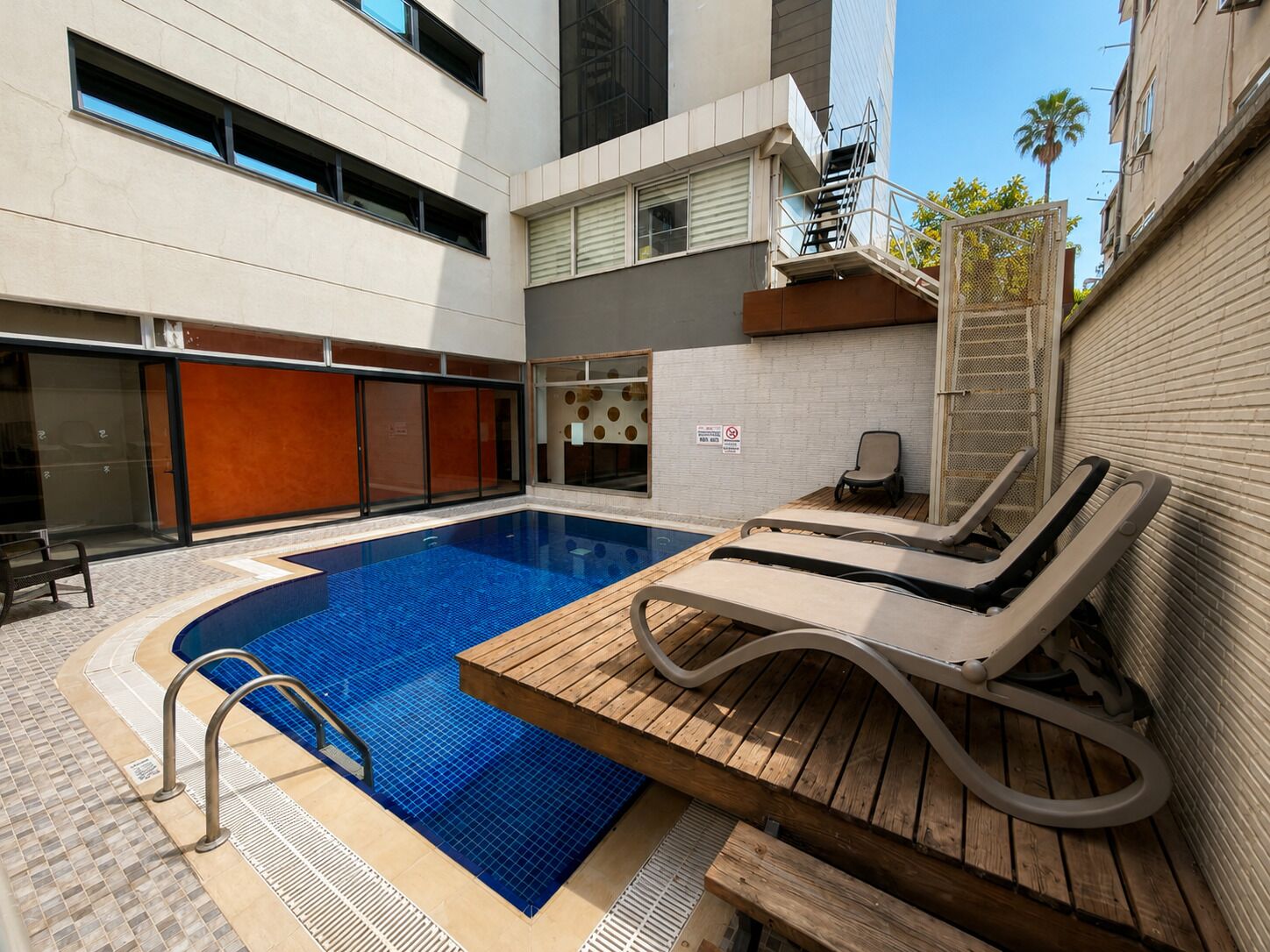 Seasonal outdoor pool, open 9:00 AM to 6:00 PM, pool umbrellas