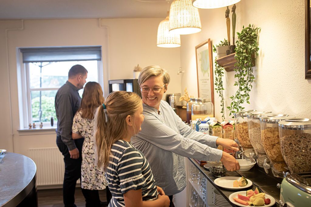 A buffet area with a variety of food options, including yogurt and granola.
