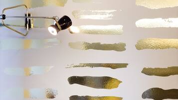 A wall with multiple paint swatches in various shades of yellow, green, and brown.