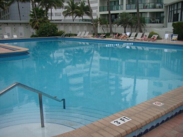 A swimming pool with lounge chairs and a 3 FT depth marker.
