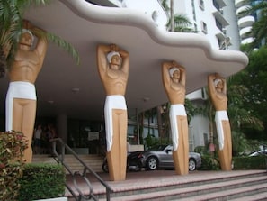 A building with a unique architectural design featuring large, abstract sculptures of human figures.