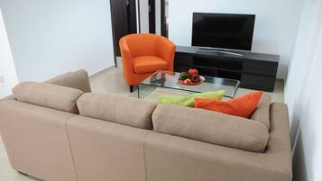 Apartment, 2 Bedrooms (Deluxe+) | Living area | Flat-screen TV