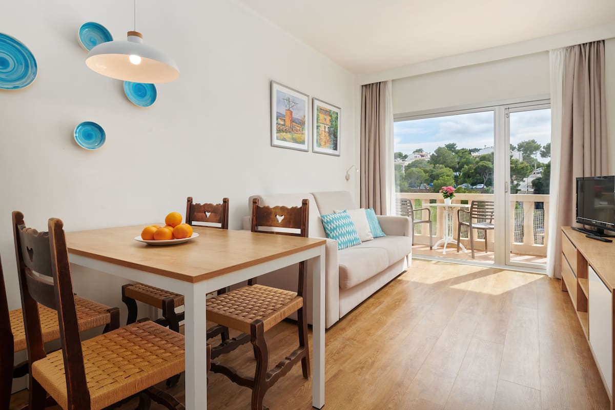 superior apartment, 1 bedroom, balcony, poolside | living area | 32-inch flat-screen tv with satellite channels, tv, ping pong